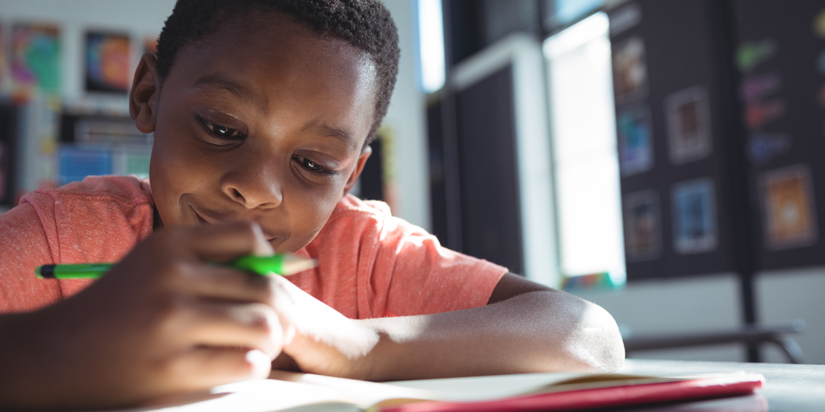 boy-writing-in-book