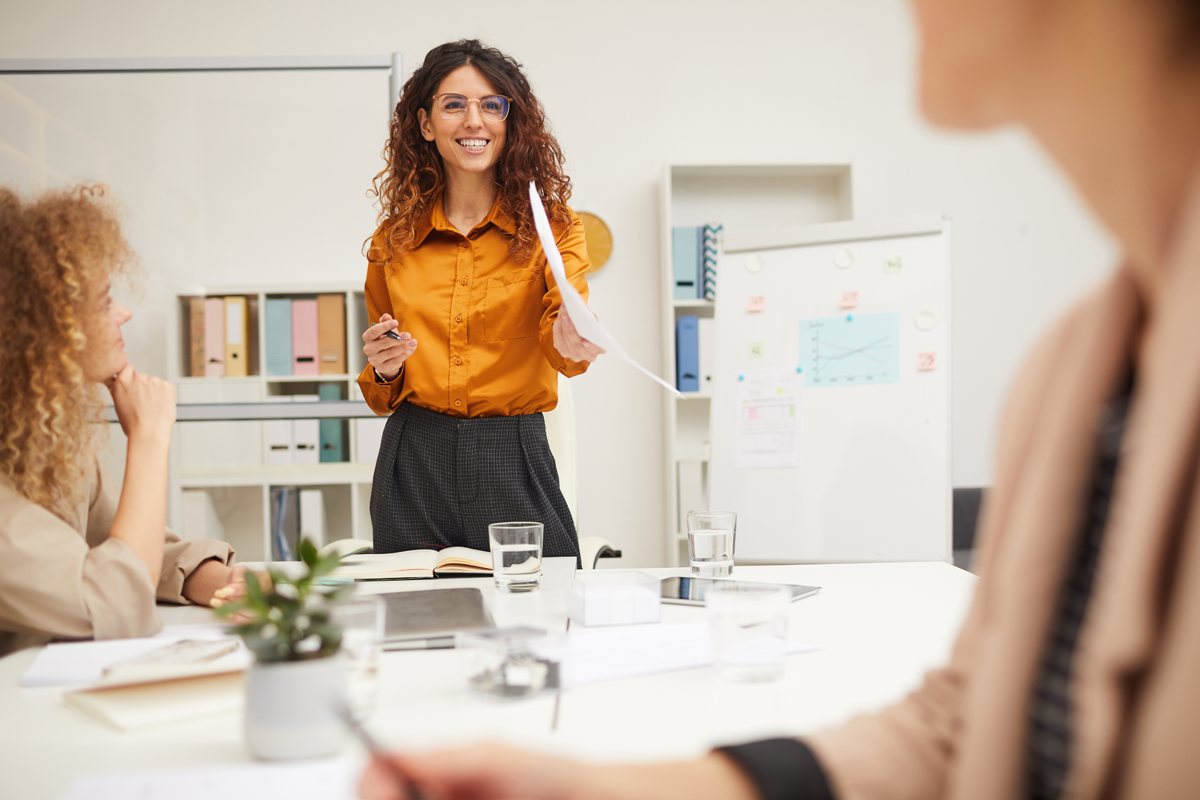 charming-businesswoman-holding-presentation-GE2CH2Y