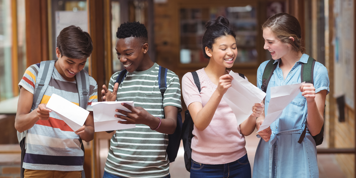 happy-classmates-looking-at-grades