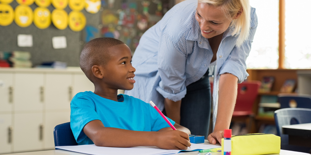 teacher-helping-boy-with-homework-PSVR65E